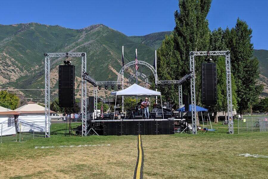 Outdoor festival stage with the Wasatch mountains behind