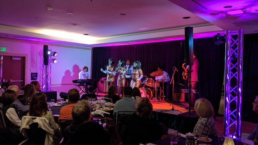 Live band with stage lighting at a corporate ballroom event