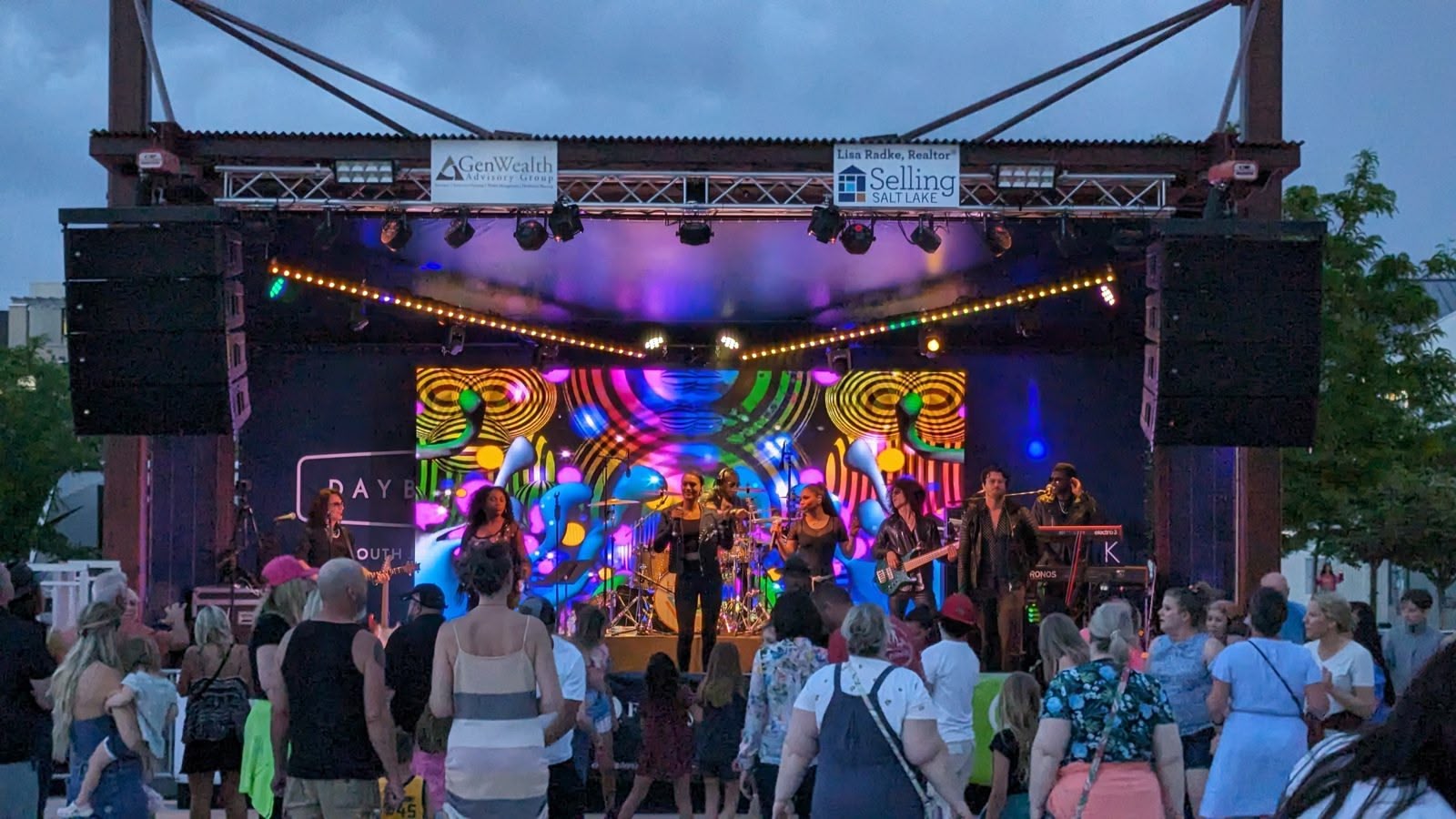 A built outdoor concert stage with truss, canopy, and line arrays