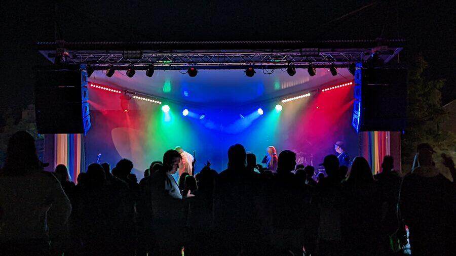 Packed dance floor with stage lighting at a party