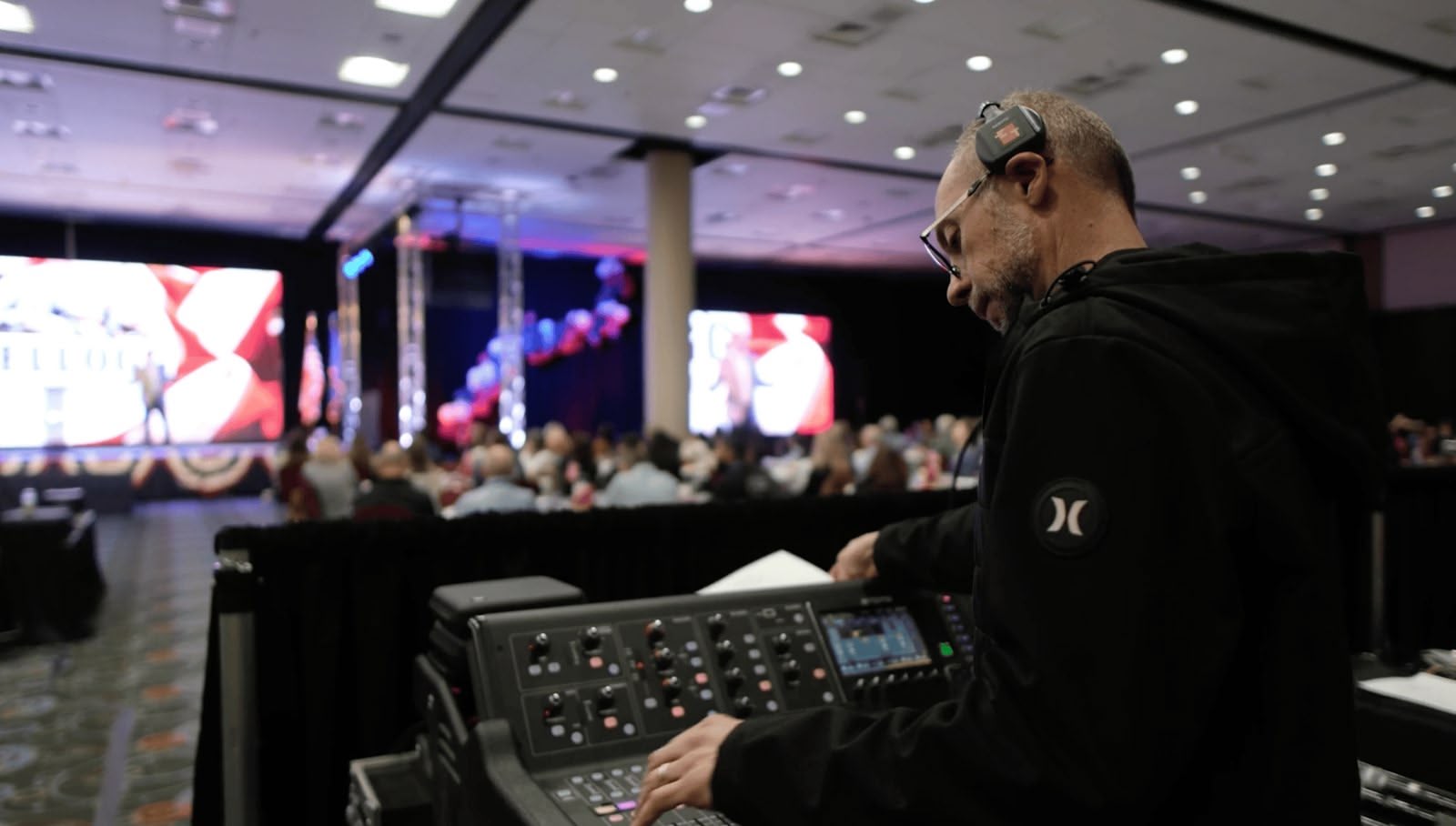 A True AV engineer mixing front-of-house sound at the Kellogg summit