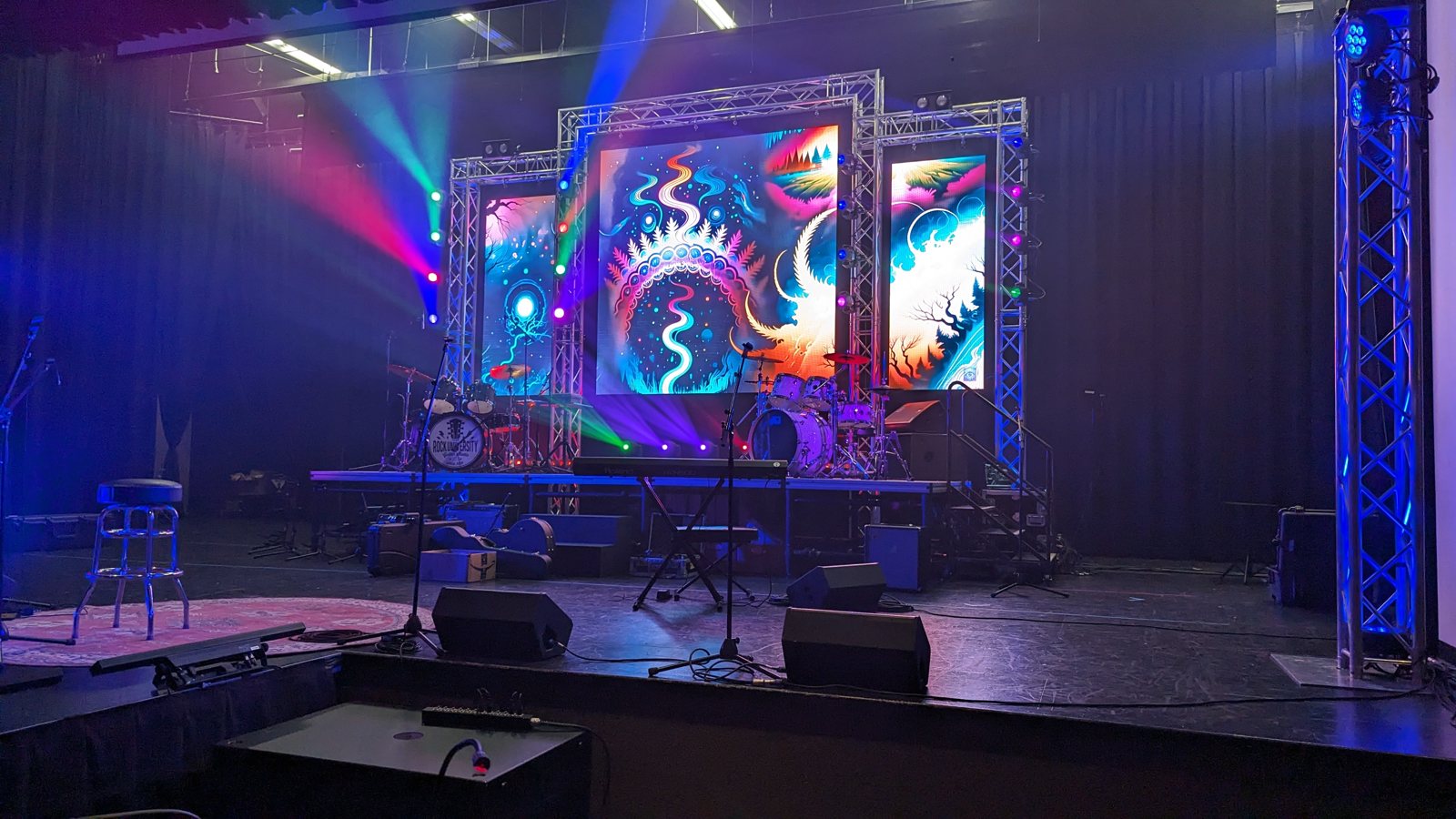 Wide view of the Rock U Live stage with the full lighting rig and LED wall