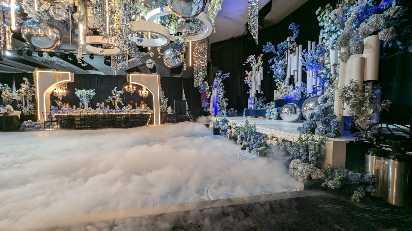 A first dance on a cloud of low fog with a floral backdrop