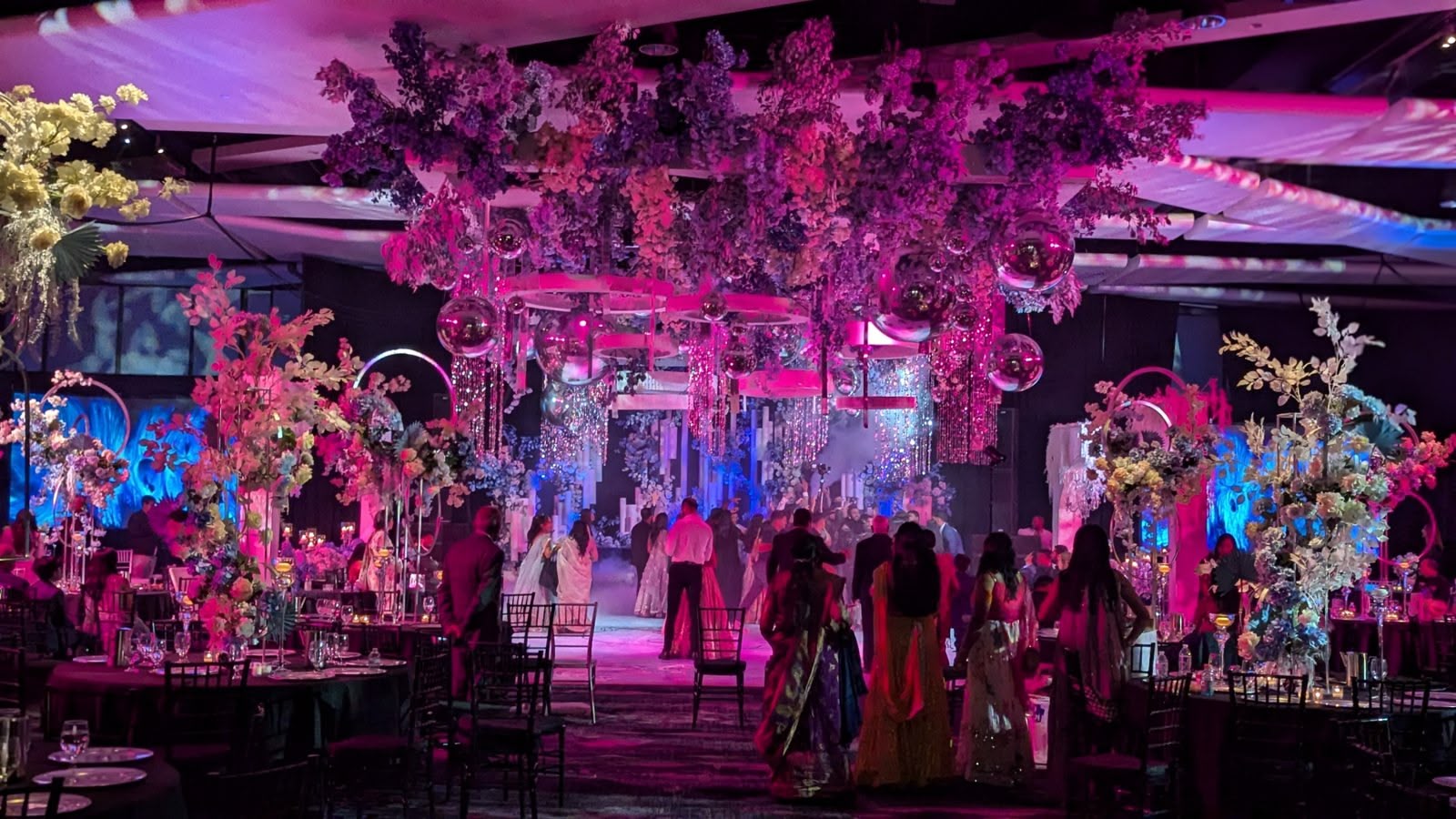 A grand ballroom bathed in pink uplighting for a formal evening
