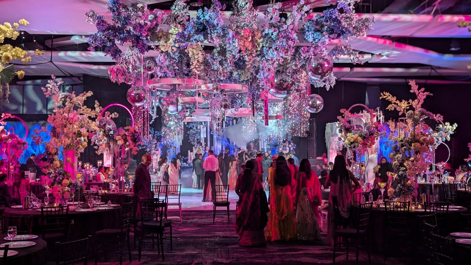 A reception room bathed in magenta uplighting
